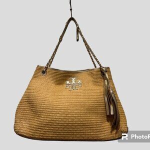 Tory Burch woven shoulder bag with gold accents and tassels